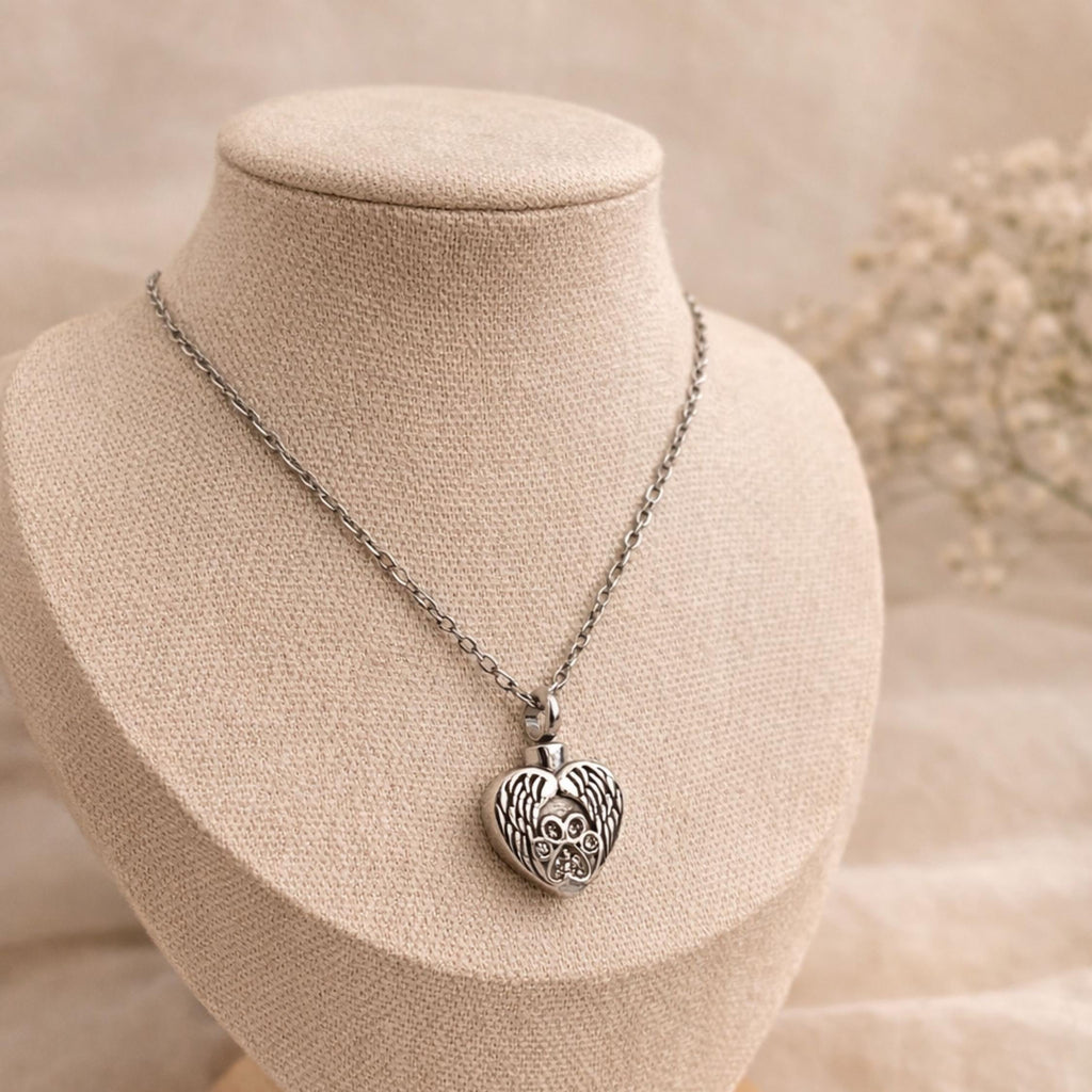 Necklace with a heart-shaped pendant on a mannequin bust with a soft background.