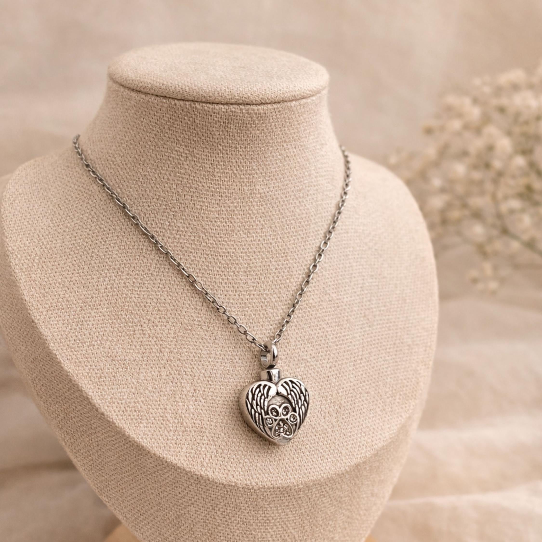 Necklace with a heart-shaped pendant on a mannequin bust with a soft background.
